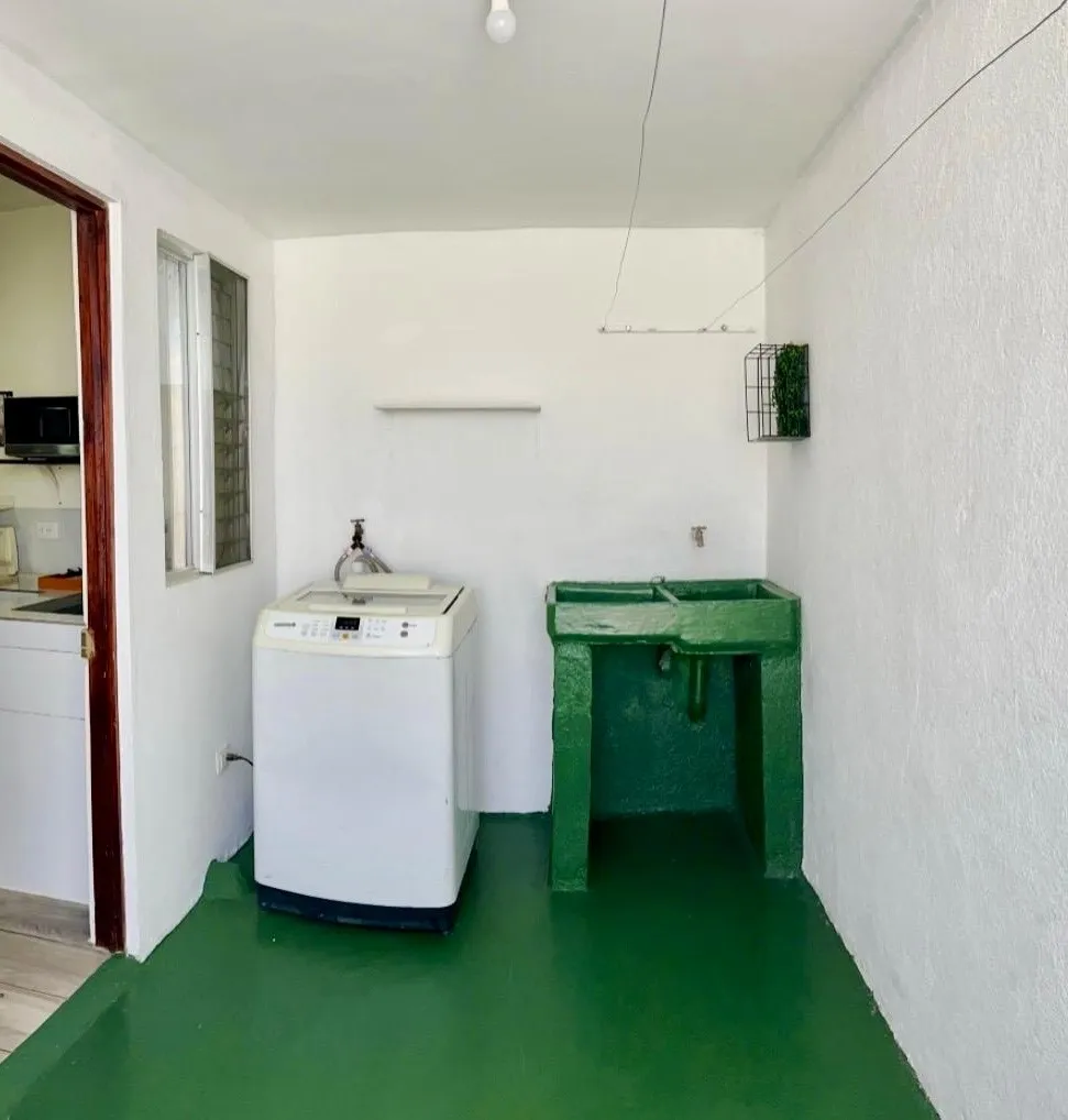 Laundry area with washing machine and sink